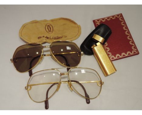 A gold plated cigarette lighter by Cartier, no:30858T, having ridged decoration, a pair of 1980's Cartier aviator framed glas