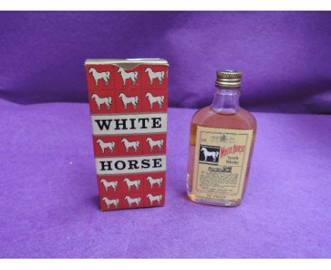 A small bottle of White Horse scotch whisky in original box 70% proof no capacity