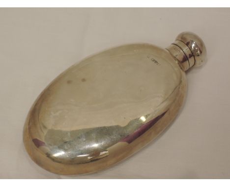 A silver hip flask of plain oval form, Chester 1912, makers mark worn 