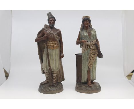 A pair of Austrian buff terracotta figures of Middle Eastern interest, circa 1890, modelled as a man and woman standing and w
