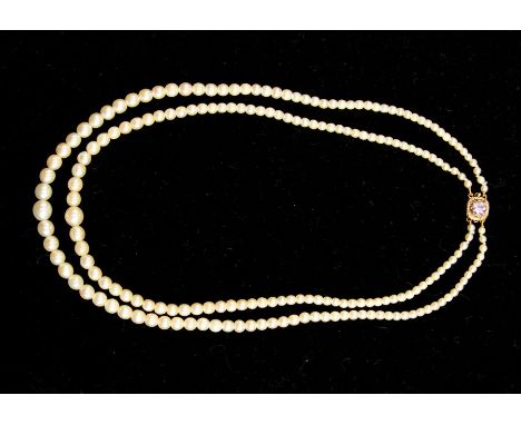 An eary 20th Century double strand graduated plain strung cultured pearl necklace&nbsp;with gold (probably 9ct, stamp indisti