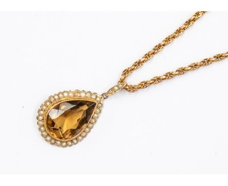 An Edwardian and pearl 9ct gold pendant, pear cut citrine set to the centre approx. 12 x 18mm, within a border of small seed 