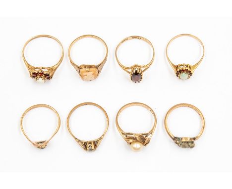 A collection of eight 9ct gold stone set dress rings, various designs, including pearl, opal, garnet cameo and paste set vers