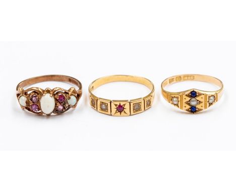 A collection of three late 19th early 20th Century gold rings to include: an 18ct gold ruby and half pearl ring, star set rub