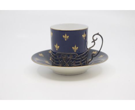 A Royal Worcester silver mounted coffee can and saucer, circa 1925, decorated with gilt fleur-de-lys on a dark blue ground, t