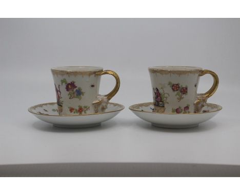 A pair of Carl Thieme porcelain 'hausmaler' decorated coffee cups and saucers, second half 19th Century, of bucket form with 