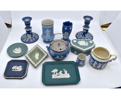 A Wedgwood Jasperware collection of ceramics, comprising a pair of early 20th Century candlesticks, a cylindrical vase, a gre