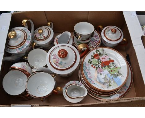 A circa 1920's Japanese tea set, decorated with Geisha girls head inside with a teapot, sugar and cream jug