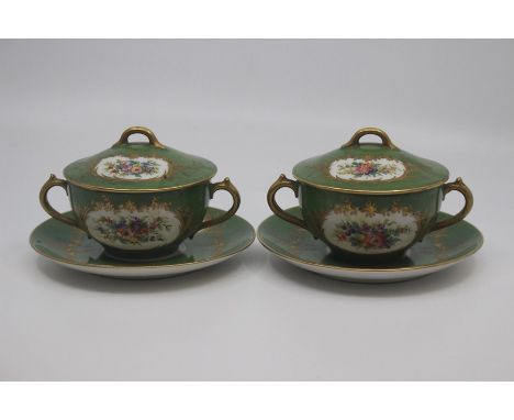 A pair of Sevres-style chocolate cups, covers and stands, late 19th Century, decorated with flower reserves against a green g
