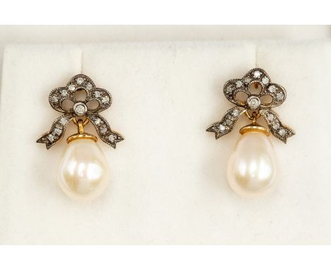 A pair of cultured pearl and diamond set earrings, bow tops set with small diamonds suspending pearl shaped cultured pearls, 