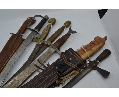 Six decorative Swords, one Machete in scabbard and a Spear (8)