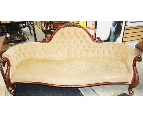 A Victorian mahogany settee, carved frame, deep buttoned back, sprung upholstered seat, raised on French cabriole legs, 100cm