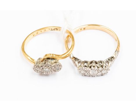 Two three stone diamond set 18ct gold rings, comprising a cross over ring set with illusion set diamonds, the other illusion 