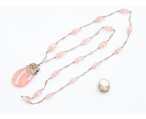 A rose quartz and white metal pendant necklace, comprising a&nbsp; pearl cut rose quartz pendant with overlaid leaf decoratio