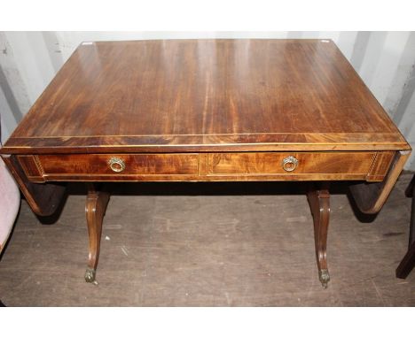 An early 19th Century mahogany sofa table, fitted with two drawers, raised on sabre legs