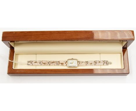 A silver cased 'Footprints' ladies watch, rectangular white enamel dial, case approx. 18 x 23mm, on a fancy textured bracelet