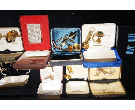 Collection of cuff-links together with a vintage lighter