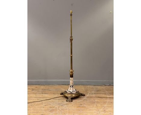 An Aesthetic period gilt-brass telescopic floor lamp, converted to electricity, with well-cast acanthus mounts and a faceted 