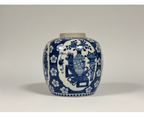 A Chinese blue and white porcelain ovoid jar, probably Kangxi period, painted with shaped cartouches enclosing flower-filled 