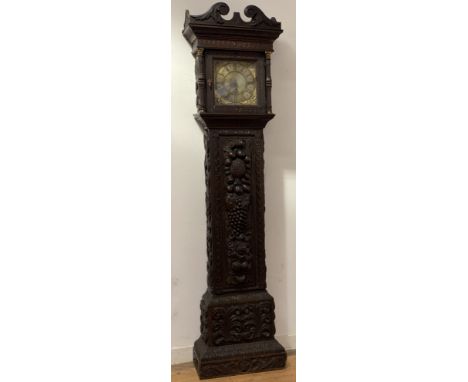 An English stained oak longcase clock, 18th century and later, the case profusely carved with scrolling acanthus leaves, frui