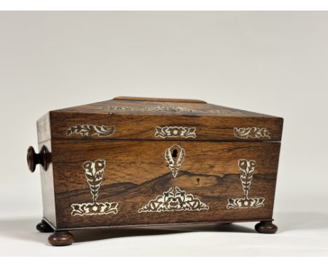 A William IV mother-of-pearl inlaid rosewood tea caddy, of sarcophagus shape, with turned handles and raised on flattened bun