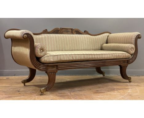 A Regency mahogany framed scroll arm sofa in the manner of William Trotter, the scrolling crest rail typically carved, above 