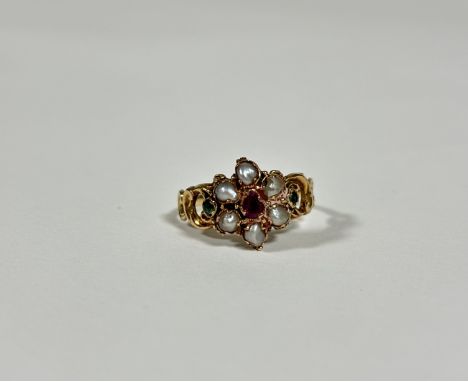 A mid-19th century emerald, ruby or garnet and seed pearl ring, set to the centre with a heart-cut stone within a band of six