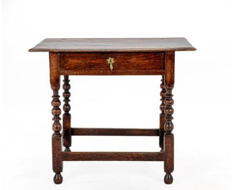 A Late 17th Century Oak Side Table, of three plank construction above a frieze drawer of nailed construction, on bobbin turne