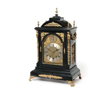 A Victorian Ebonised and Gilt Metal Mounted Chiming Table Clock, circa 1890, arched pediment with flame gilt metal finials, c