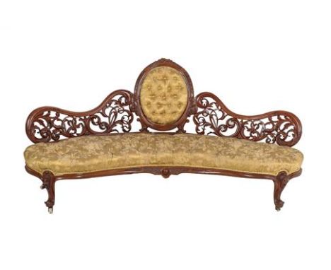 A Victorian Carved Walnut Eight Piece Salon Suite, circa 1870, recovered in floral gold silk, comprising a curved sofa with m