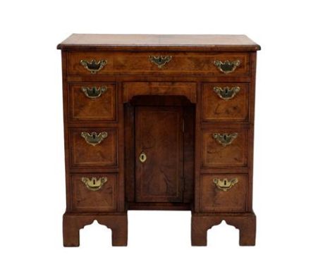 A George I Walnut, Crossbanded and Feather-Banded Kneehole Dressing Table, early 18th century, the crossbanded top with re-en