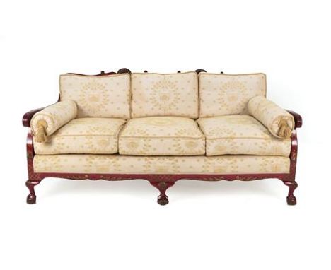 A 1920's Red Japanned Three-Seater Bergère Sofa, the single cane back support with carved shells, the arms decorated with Ori