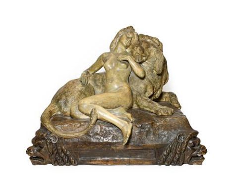 A Goldscheider Terracotta Figure Group, early 20th century, modelled as a maiden asleep against a recumbent lion, on a cushio