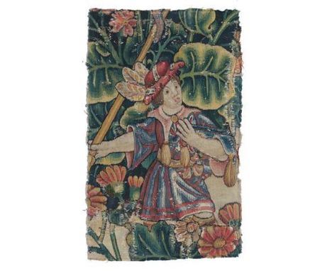 A Flemish ''Tapestry'' Fragment, probably 17th century, worked in silk and wool depicting a huntsman within a rich floral lan