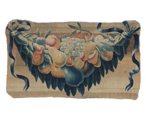 A 17th Century Flemish Tapestry Fragment, worked in wool and silk depicting a leafy swag with fruits flanked by trailing ribb