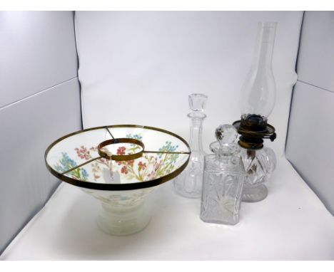 A cut glass oil lamp + milk glass floral shade, together with two cut glass decanters. (3)