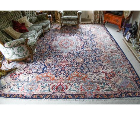 A mid-20th century Qum style rug, the central pale green, light blue, pale brown and madder floral decorated pendant medallio