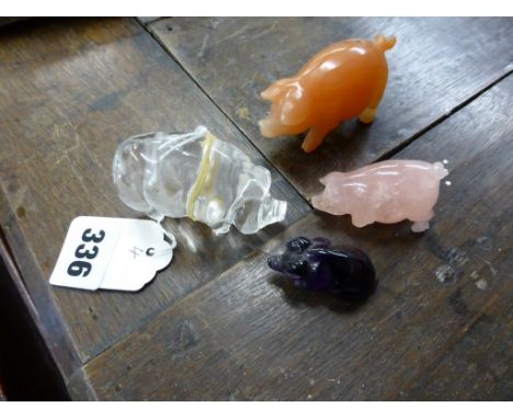 Four carved stone miniature pigs, carved from rock crystal, rose quartz, cherry quartz and amethyst, largest 2 5/8 x 1¾in. (6