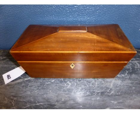 An early 19th Century mahogany sarcophagus shaped tea caddy, opening to reveal two tea compartments to either side and well i