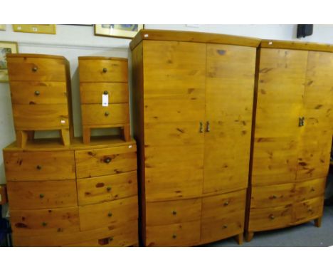 A modern light wood bow fronted bedroom suite, consisting of two wardrobes with four drawers under, both measuring 80½in (205