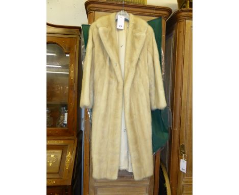 A three quarters length pastel mink coat.