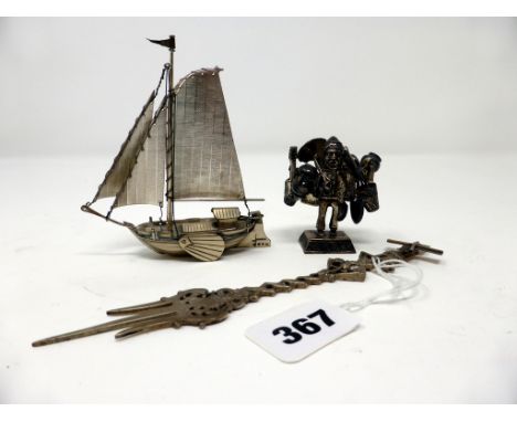 A Dutch Miniature silver China trade sailboat, possibly by J. Verhoogt (unmarked), together with a miniature Oriental street 