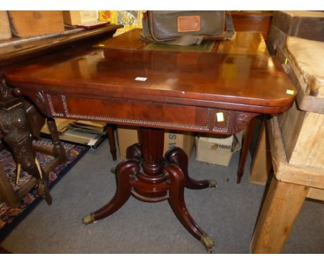 A mahogany Regency foldover card table, with rosewood cross banding, D-shaped top with green baize lining, turned column with