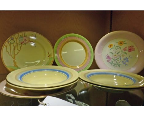 A collection of various Clarice Cliff plates & bowls, consisting of four blue & brown 'Liberty Stripe' bowls; a green, pink a
