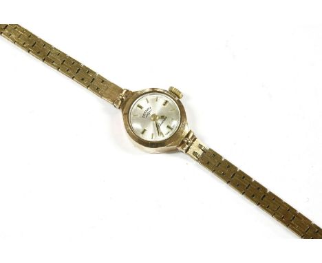 A ladies 9ct gold Rotary mechanical bracelet watch, with raised gilt and black baton markers to an integral link bracelet and