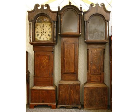 Three oak longcase clock cases, one with an eight day striking movement, the painted dial fire damaged, tallest 219cm