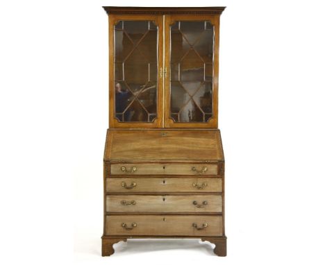 A late George III mahogany bureau bookcase, having pair of astragal glazed doors above fall front and four graduated drawers 