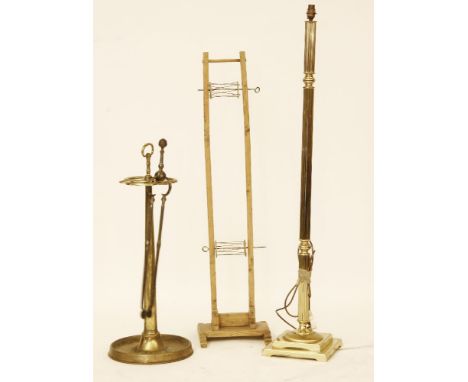 A Victorian brass three division stick stand, on circular spreading base, 84cm high, together with a reeded brass standard la