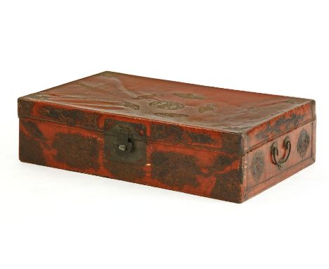 A Chinese red embossed trunk, 20th century, the top decorated with five bats surrounding a shou roundel, the sides with lotus