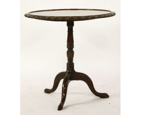 A 19th century mahogany supper table, the circular top with pie crust edge, over turned support and tripod support with claw 